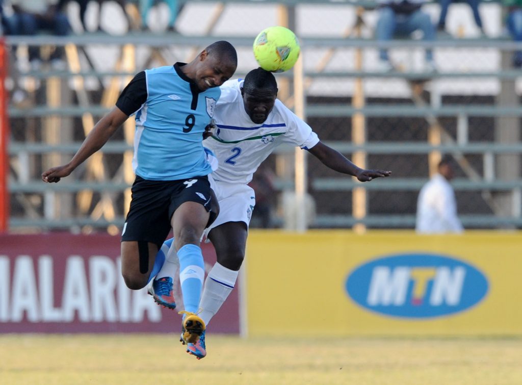 Jerome Ramatlhakwane of Botswana battles with Mokhahlane Ralekoti of Lesotho during the Cosafa Cup match between Lesotho and Botswana on the 09 July 2013 at Arthur Davies Stadium ©Muzi Ntombela/BackpagePix