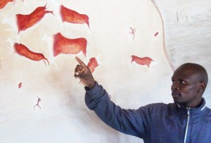 Site manager Teboho Moloisane shows journalists some of the Baroana art.