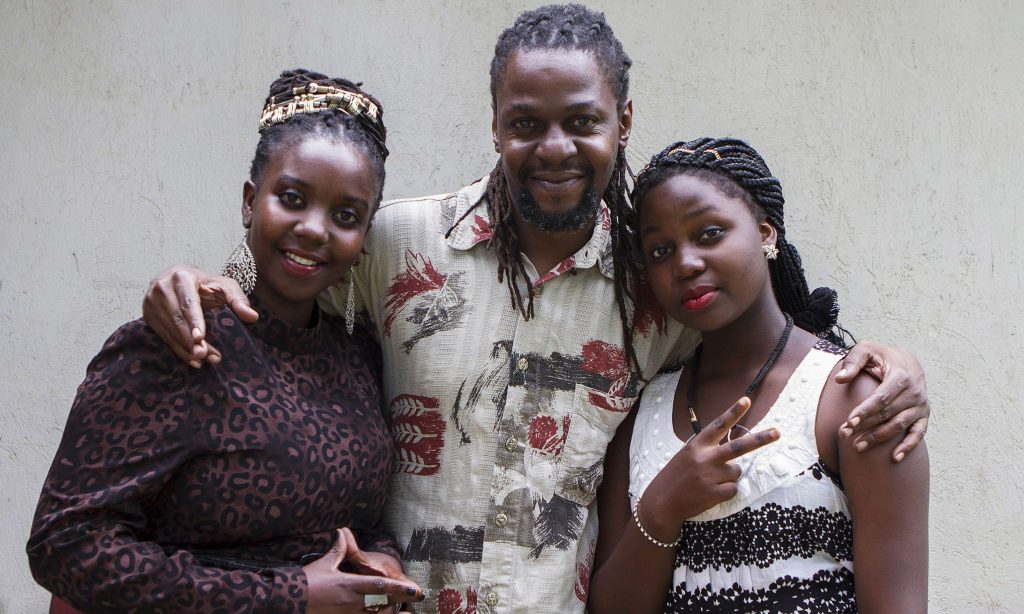 TO GO WITH AFP STORY BY AMY FALLON - A picture taken on April 17, 2015 shows Newzbeat's host Sharon Bwogi AKA Lady Slyke (L), writer and producter Daniel Kisekka aka "Survivor" (C) and rapper Zoe Kabuye aka "MC Loy" posing at the company's office in Kampala. "Newzbeat" makes a catchy change from a standard news bulletin: Ugandans call the broadcasters "rap-orters", a youth team of hip hop artists turned journalists rapping the headlines. AFP PHOTO/ ISAAC KASAMANIISAAC KASAMANI/AFP/Getty Images