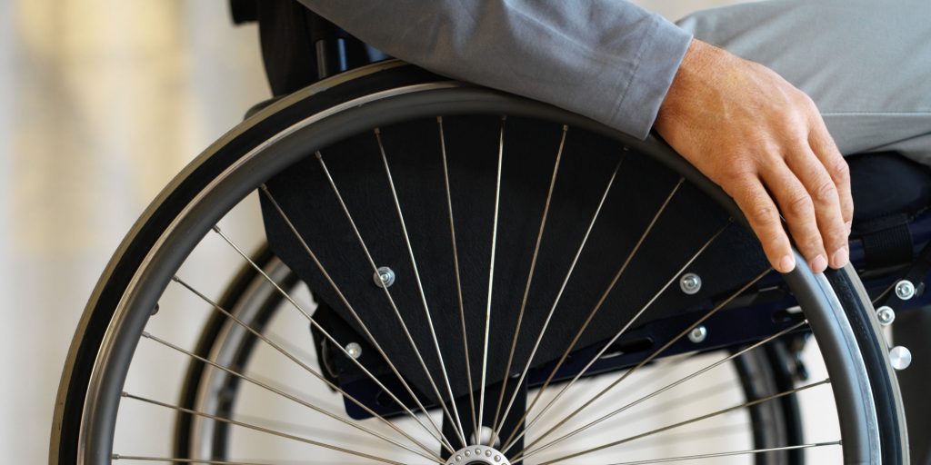 close up mid section view of a man sitting in a wheelchair