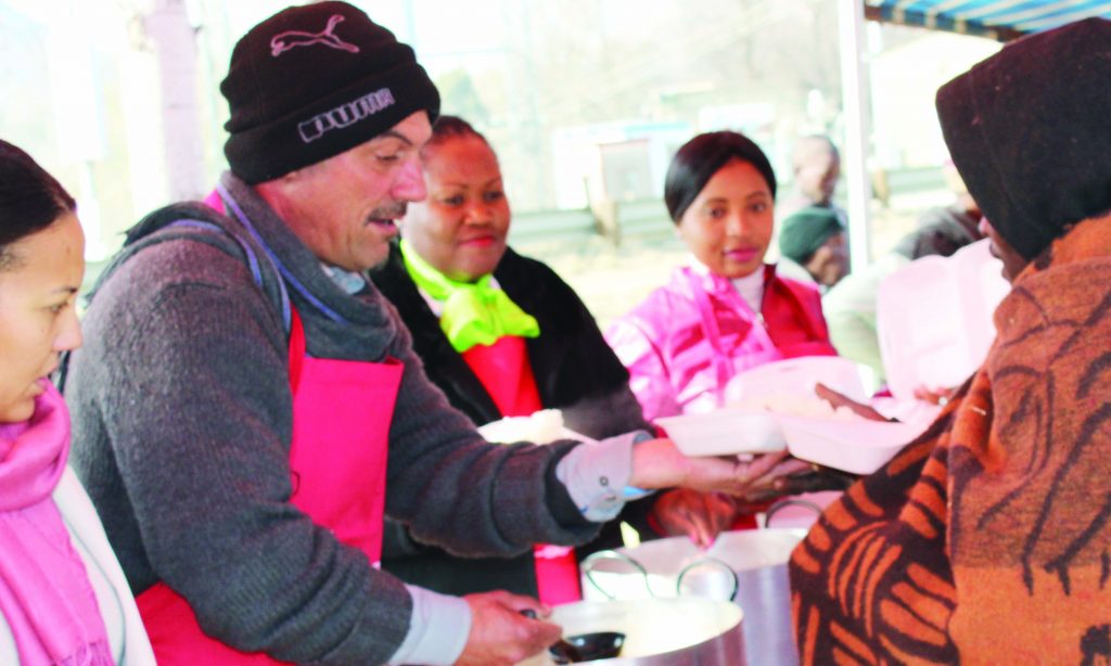 DOUGIES Kitchen's Douglas Muller dishes food to some of the vulnerable members of the community in Maseru on Tuesday.