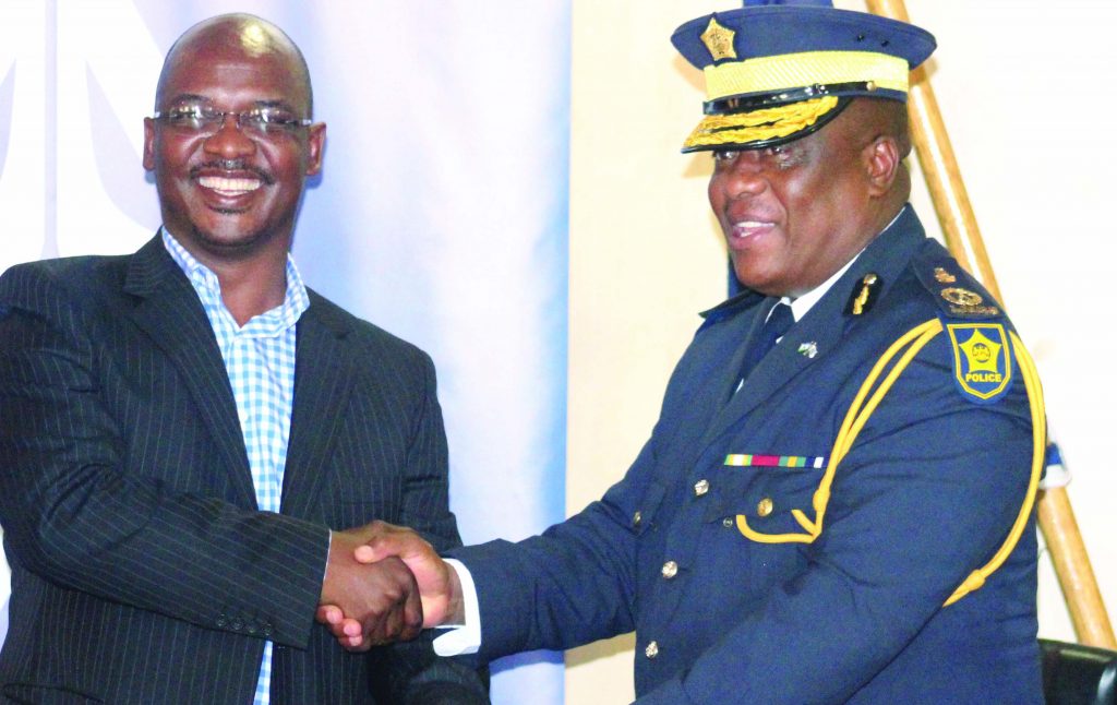 Metropolitan Lesotho MD Nkau Matete shake hands with Acting  Police Commissioner Keketso Monaheng,