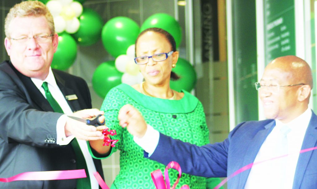 FROM left Nedbank Lesotho MD PJ Bouwer, CBL Governor Dr Retšelisitsoe Matlanyane and Accountant-General Sam Mphaka cut the ribbon to officially open the TY branch