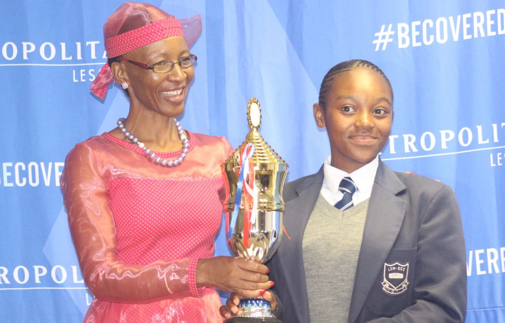 Position one holder at LGSCE level Mamasoatsi Pearl Kopeka from Leribe English Medium receives prizes from Metropolitan MD Nkau Matete and Dr Phamotse  