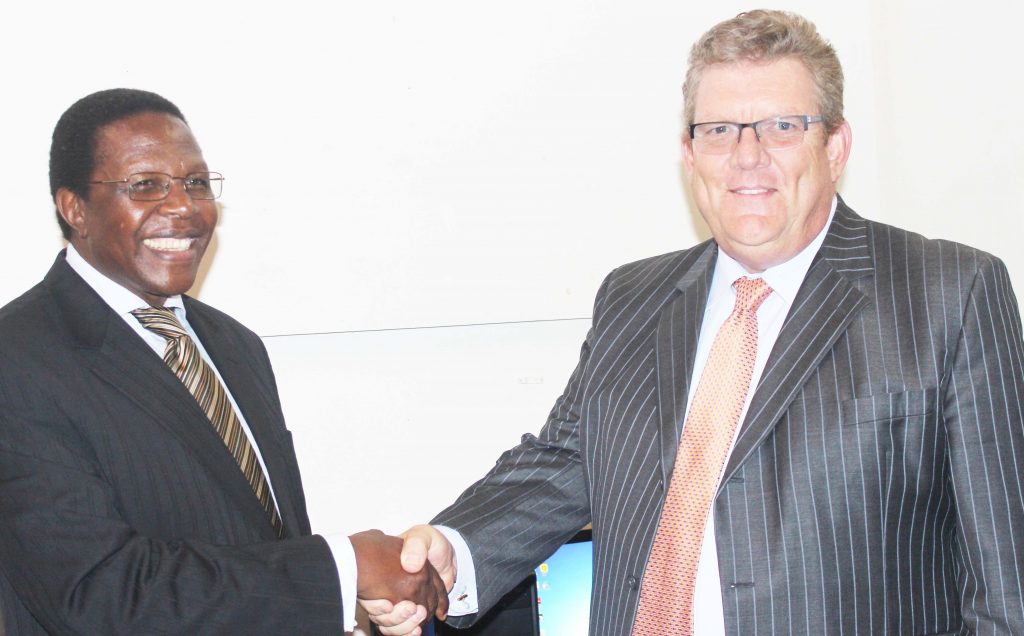 Nul Vice -Chancellor Nqosa Mahao,left, shake hands with Nedbak Managing Director PJ Bouwers on Wednesday at Roma Campus during the handing over ceremony 