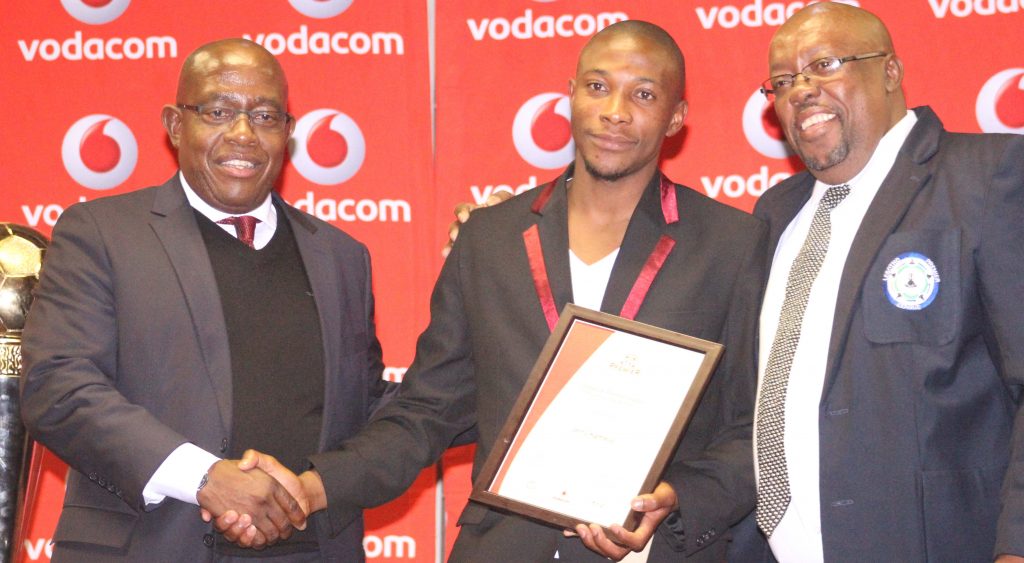 LeFA president Salemane Phafane and Premier League chairman Leuta Leuta hands over the Player of the Season accolade Jerry Kamela of Lioli