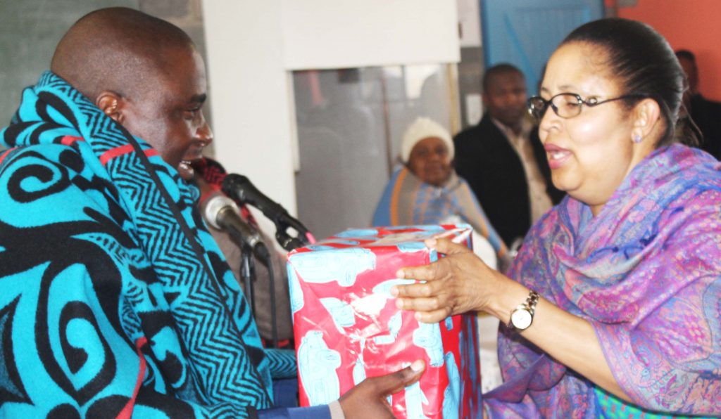 Member of Parliament for Rothe Constituency Ms Manthabiseng Phohleli hand over a present to Minister of Energy and Meteorology  Selibe Mochoboroane